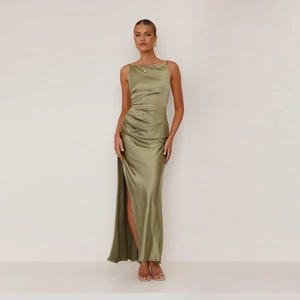 Detail of olive green satin dress featuring high side slit and elegant waist pleats