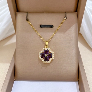 Golden clover necklace with purple heart-shaped stones and white zircon crystals