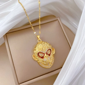 Luxury gold titanium necklace featuring a monkey pendant with red enamel and zircons