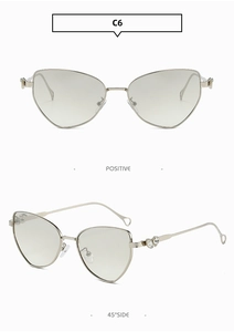 Cat eye metal sunglasses with silver frame and heart-shaped rhinestone detailing on temples
