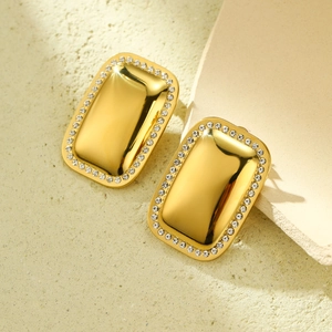 Macro shot of 18k gold plated rectangular earrings featuring sparkling crystal borders