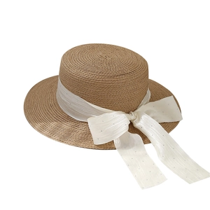 Vintage flat top boater hat with straw texture and white ribbon bow decoration