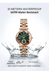 Detail of rose gold watch with emerald green dial and water splashes for 3ATM waterproof
