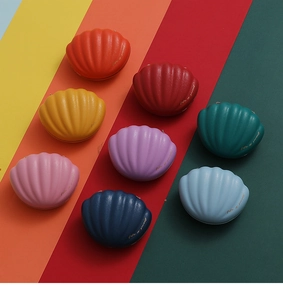 Creative shell-shaped wedding favor boxes in colorful leather textures with gold print