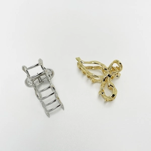 Elegant gold and silver bow-shaped alloy hair clips with hollow metal design for women