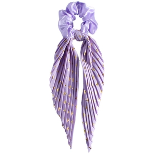 Detail of purple satin scrunchie with pleated streamer and gold cross pattern