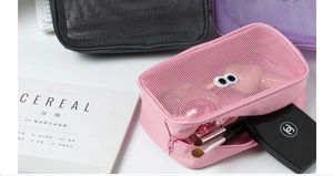 Close-up of mesh makeup bag with cute googly eyes showing spacious storage capacity