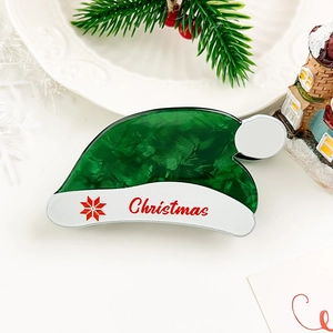 Detail of green Christmas hat hair claw clip with snowflake and letter print
