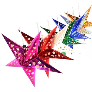 Close-up of laser-cut hollow star ornaments with moon and star patterns in multiple colors