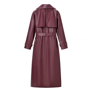 Burgundy faux leather long trench coat for women featuring a back storm flap and waist belt
