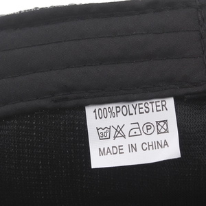 Detailed view of the linen cotton flat cap interior with 100% polyester washing label