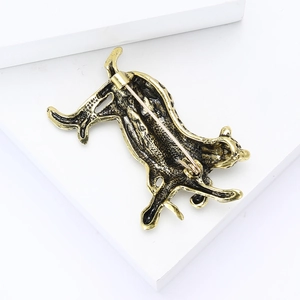 Detailed view of vintage gold leopard brooch with enamel on a white stand