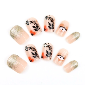 Short square press-on nails with black leaf, leopard print, and eye design glitter finish