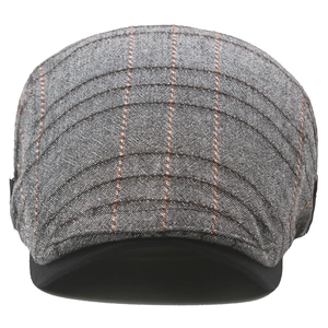 Detailed view of gray plaid cotton flat cap with black brim and neat stitching