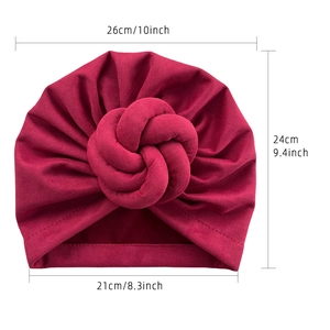 Burgundy solid color turban hat with ethnic twisted knot and soft knitted fabric texture