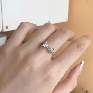 Close-up of S925 sterling silver bow ring with triangle zircon and pave setting