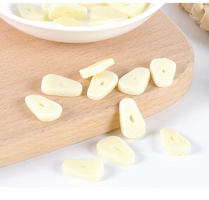 Realistic PVC garlic slices on a wooden cutting board for DIY dollhouse miniatures