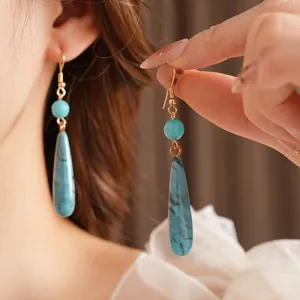 Bohemian turquoise water-drop earrings with vintage gold hooks for a classic ethnic look