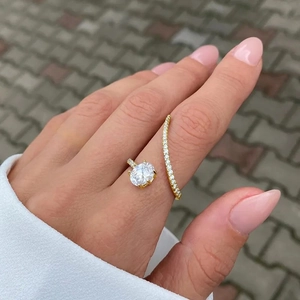 Detailed view of an adjustable gold-plated ring with large oval zircon and pavé setting