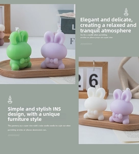 Detail of three cute rabbit candles in green purple and white on a wooden tray