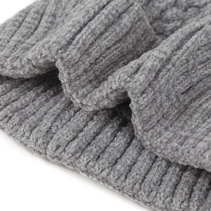 Macro shot of grey cable knit texture with soft plush faux mink fur fibers on warm beanie