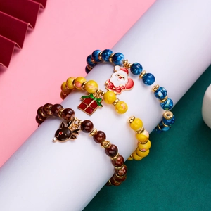 Detailed view of three festive Christmas beaded bracelets with Santa, gift, and reindeer charms