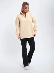 Detail of half-zip stand collar and beige knitted fabric on women's pullover sweatshirt
