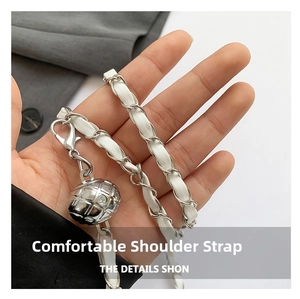 Detail of white leather and silver metal chain strap with rhinestone adjustment ball