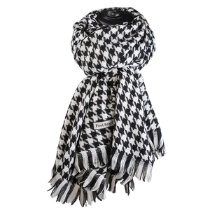 Classic black and white houndstooth winter scarf with tassels shown on a white background