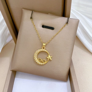 Elegant gold titanium steel necklace featuring crescent moon and star sparkling pendants
