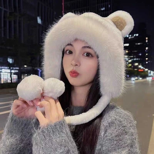 Detailed texture of white plush bear ear bucket hat featuring soft faux fur finish