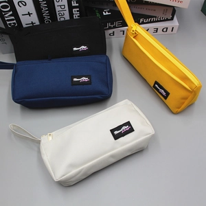 Stack of canvas zipper pencil cases in black, navy, yellow, and white with side handles