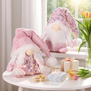 Pink sequin knit hat Christmas gnome figurines set on white tabletop with tulips