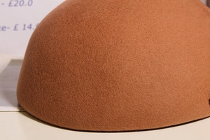 Macro detail of caramel brown wool felt material on a classic French beret hat