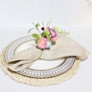 Close-up of Easter egg napkin ring with flowers and berries on a white porcelain plate