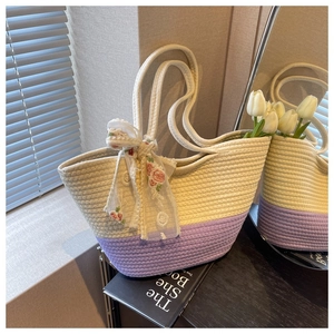 Detailed woven texture of beige and purple tote bag with decorative floral scarf