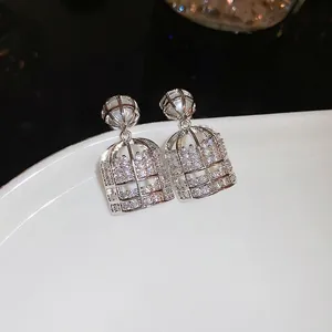 Elegant silver birdcage drop earrings with pearls and micro-pave cubic zirconia stones