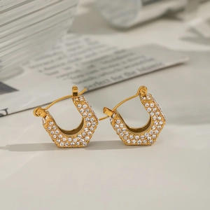 Macro shot of 18K gold-plated U-shaped earrings with sparkling cubic zirconia inlay
