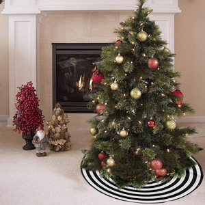 Detail of round black and white striped Christmas tree skirt in a cozy home setting