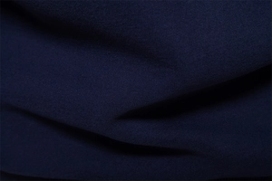 Close-up of navy blue sweatshirt fabric showing the premium fine knit texture and material