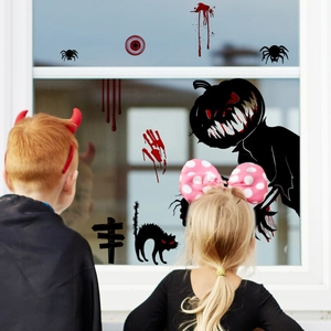 Close-up of Halloween bloody handprints and spooky pumpkin decals on a window surface