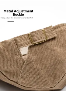 Detail shot of the adjustable metal buckle on khaki cotton twill newsboy cap