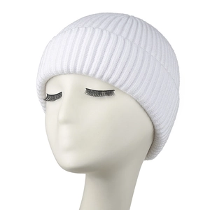 Detailed macro view of a warm white knitted beanie with a folded cuff on a mannequin.
