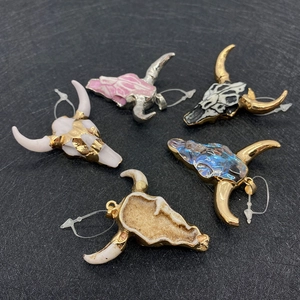 Five assorted bull head acrylic pendants in various colors displayed on a black background
