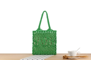 Close-up of grass green macrame woven tote bag featuring intricate cotton rope knots
