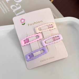 Detail of four colorful Morandi wave-edged rectangular hair clips on a display card