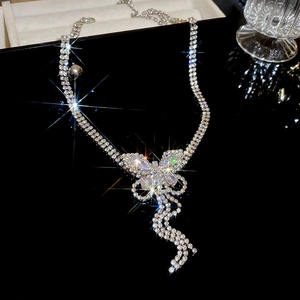 Macro shot of silver butterfly necklace featuring tassels and sparkling rhinestones