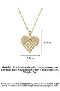 Macro detail of hollow heart pendant necklace with micro-pave crystals and titanium chain