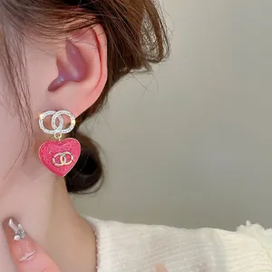 Elegant gold plated heart earrings with pink enamel texture and sparkling zircon studs