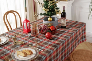 Detail of red and green plaid Christmas tablecloth with decorative tassel edges